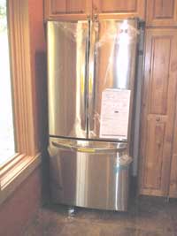 LG refrigerator fits into the space among the cabinets